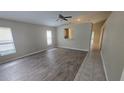 Spacious living room features luxury vinyl plank flooring, neutral walls, and a ceiling fan at 6517 Summer Cove Dr, Riverview, FL 33578