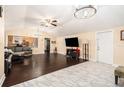 Living room featuring vaulted ceilings, stylish light fixtures, and hardwood floors at 9220 Mcintosh Rd, Dover, FL 33527