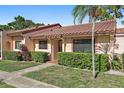 Attractive home exterior with red tile roof, lush landscaping, and a welcoming walkway at 9737 86Th Ave, Seminole, FL 33777