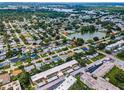 Serene aerial view of a neighborhood featuring lush green landscapes and shimmering lake views at 9945 47Th N Ave # 210, St Petersburg, FL 33708