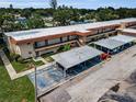 Property featuring multiple units with balconies and convenient covered parking for residents and guests at 9945 47Th N Ave # 210, St Petersburg, FL 33708