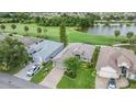Aerial view of property showcasing a well-maintained home with lush landscaping and a nearby golf course at 10232 Buncombe Way, San Antonio, FL 33576