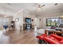 Spacious living room with hardwood floors, neutral walls, and sliding glass doors to screened porch at 10232 Buncombe Way, San Antonio, FL 33576