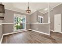 Dining room with neutral walls, crown molding, and hardwood floors at 10314 Deepbrook Dr, Riverview, FL 33569