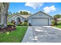 Exterior shot of single story home with two car garage and walkway at 10314 Deepbrook Dr, Riverview, FL 33569