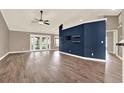 Living room with neutral walls, hardwood floors, and french doors at 10314 Deepbrook Dr, Riverview, FL 33569