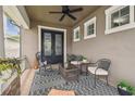Inviting covered front porch with stylish furniture and decor, creating a cozy outdoor living space at 10422 Fenceline Rd, New Port Richey, FL 34655