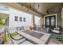 Inviting covered front porch with stylish furniture and decor, creating a cozy outdoor living space at 10422 Fenceline Rd, New Port Richey, FL 34655