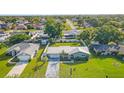 An aerial view showcases the property's layout with a fenced backyard, lush lawns, and nearby community at 11226 Murraysville Dr, Spring Hill, FL 34609