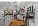 Modern kitchen with granite countertops, stainless steel appliances, and hardwood floors offering ample space at 11226 Murraysville Dr, Spring Hill, FL 34609