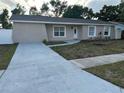 Inviting single-story home featuring a well-maintained yard and a newly painted long driveway at 1215 Windsor Cir, Brandon, FL 33510