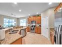Spacious kitchen with stainless steel appliances, granite countertops, and tile flooring at 1328 Rushgrove Cir, Dover, FL 33527