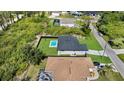 Overhead shot of the property displaying the pool and black fence, surrounded by trees and neighboring homes at 14009 Wenzel Ave, Port Charlotte, FL 33981