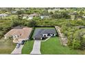 Drone shot of the house showing the black fence, driveway, and landscaping at 14009 Wenzel Ave, Port Charlotte, FL 33981