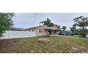 Quaint home featuring a fenced yard, small fire pit, and covered parking at 1401 43Rd S St, St Petersburg, FL 33711