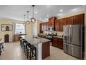 Spacious kitchen with stainless steel appliances, granite countertops, and a large center island with seating at 15430 Caravan Ave, Odessa, FL 33556
