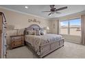 Cozy bedroom with large window, ceiling fan, and luxurious furnishings at 15430 Caravan Ave, Odessa, FL 33556