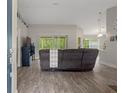 Open-concept living area with modern flooring, neutral color palette, and plenty of natural light at 16473 Scaup Duck Ave, Weeki Wachee, FL 34614