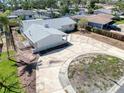 An aerial view showcases the property, highlighting its spacious driveway and location within a residential neighborhood at 1897 Dolphin S Blvd, St Petersburg, FL 33707