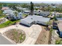 A bird's-eye view of the house, showing the paved driveway, the light gray roof, and its landscaping at 1897 Dolphin S Blvd, St Petersburg, FL 33707