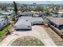 An aerial view displays the neighborhood and layout with circular drive and water views beyond the surrounding homes at 1897 Dolphin S Blvd, St Petersburg, FL 33707