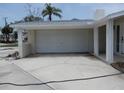 A spacious two-car garage with white door and matching brick exterior under a covered portico at 1897 Dolphin S Blvd, St Petersburg, FL 33707