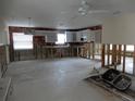 Spacious kitchen area featuring white cabinetry, a ceiling fan, and dual windows at 1897 Dolphin S Blvd, St Petersburg, FL 33707