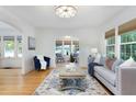 Bright living room featuring a decorative rug, neutral-toned sofa with pillows, and natural light at 1915 10Th N St, St Petersburg, FL 33704