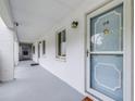 Inviting condo hallway with a light-colored door and a small window at 2060 Marilyn St # 114, Clearwater, FL 33765