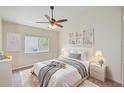 Cozy bedroom with a queen-size bed, soft lighting, and a ceiling fan at 25729 Aldus Dr, Land O Lakes, FL 34639
