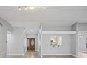 Bright living space with light-colored walls and floors, stylish door, and kitchen views at 3121 Egret Ter, Safety Harbor, FL 34695