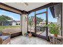 A cozy sunroom features tile flooring, neutral walls, and views of the front yard at 4512 Superior Ln, Clearwater, FL 33762