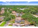 Aerial view showcasing a property with lush greenery, a solar panel roof, and boundary lines at 4640 W Lamb Ave, Tampa, FL 33629