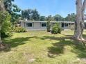 Cozy single-story home surrounded by lush greenery and mature trees at 4722 Harris Ave, Sarasota, FL 34233