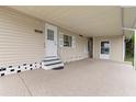 Spacious carport featuring a door entrance to the home and ample covered parking at 7118 El Meyers St, Zephyrhills, FL 33541