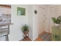 Bright entryway featuring neutral walls, tile flooring, and a charming decorative plant and table at 7304 W Country Club N Dr # 113, Sarasota, FL 34243