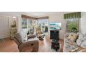 Cozy living room with hardwood floors, a large window view, comfortable seating, and a flatscreen TV at 7304 W Country Club N Dr # 113, Sarasota, FL 34243