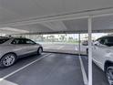 Assigned covered parking space with view of the waterfront area with palm trees at 7600 Sun Island S Dr # 603, South Pasadena, FL 33707