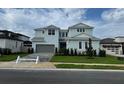 Beautiful two-story home with a manicured lawn and a two-car garage with a brick paved driveway at 8316 Golden Beach Ct, Parrish, FL 34219