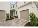 Beautiful home entrance with stone paver driveway leading to the front door and two-car garage at 8316 Golden Beach Ct, Parrish, FL 34219