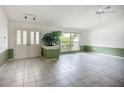 Inviting living room with double door entry, lots of natural light, and a stylish planter at 8822 Misty Creek Dr, Sarasota, FL 34241