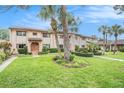 Charming two-story townhome showcasing landscaped front yard, manicured hedges, and a tile roof at 9521 86Th Ave # 9521, Seminole, FL 33777