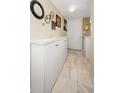 Entryway with tiled floor has ample storage with white cabinets and decorative wall accents at 960 Virginia St # 202, Dunedin, FL 34698