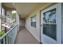 Hallway showcases the unit's entrance with a secure door, adjacent to well-lit stairs at 960 Virginia St # 202, Dunedin, FL 34698