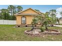 Beautifully landscaped front yard with decorative brick border, flower pots and yard decor at 14494 Copeland Way, Brooksville, FL 34604