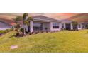 Expansive backyard featuring lush green grass, a screened-in lanai, and well-maintained landscaping at 16126 San Donato Pl, Bradenton, FL 34211