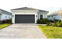 This single-Gathering home has a brick driveway, attached garage, and manicured landscaping at 16126 San Donato Pl, Bradenton, FL 34211
