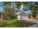 Beautiful exterior view of a two-story home with a well-maintained lawn at 20109 Bay Cedar Ave, Tampa, FL 33647