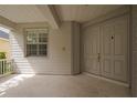 Charming covered front porch featuring classic double doors and a shuttered window at 20109 Bay Cedar Ave, Tampa, FL 33647