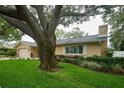 Lovely home showcasing a lush lawn, mature trees, and a welcoming front facade at 2273 Willowbrook Dr, Clearwater, FL 33764